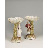 A PAIR OF GERMAN STYLE PORCELAIN COMPORTS, with basket effect tops with allover painted and