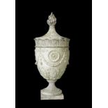 A "COADE" STONE URNwith a spirally fluted top surmounted by a flambeau finial, the body with