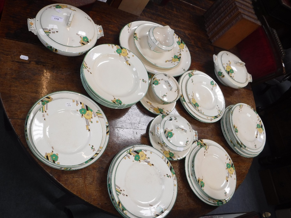 A 1930'S ART DECO DINNER SERVICE with a geometric decoration above a cream background