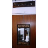 A RECTANGULAR WALL MIRROR within carved and gilt Chinese panels and a similar carved panel with