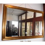 A LARGE RECTANGULAR BEVEL EDGE WALL MIRROR in gilt frame