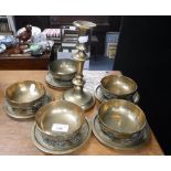 A COLLECTION OF CHINESE BRASS RICE BOWLS with saucers, decorated with dragons, and a single brass
