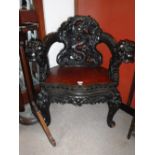 A CHINESE STAINED HARDWOOD ARMCHAIR, all over carved with dragons