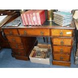 A VICTORIAN WALNUT PEDESTAL DESK with green leather top and Gothic brass handles 41.5" wide