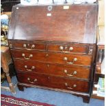 A GEORGE III OAK BUREAU ON BRACKET FEET 36" WIDE