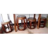 A SET OF FOUR CHINESE HARDWOOD BARREL-FORM STOOLS with glass tops and shelves