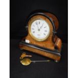 A VICTORIAN WALNUT AND EBONISED CASED MANTEL CLOCK 8" high (key and pendulum in office)