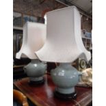 A PAIR OF ORIENTAL CELADON TABLE LAMPS, in the form of vases, with cream shades