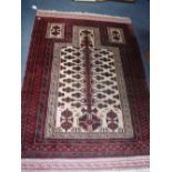 A CREAM GROUND PERSIAN MASHAD PRAYER RUG with red borders 42" x 60" (plus fringes)