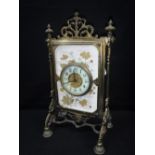A VICTORIAN BRASS AESTHETIC PERIOD MANTEL CLOCK, the movement mounted within a ceramic plaque