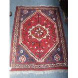 A RED GROUND PERSIAN DESIGN RUG 42" x 59" (plus fringes)