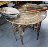 AN INDIAN FOLDING TABLE, with brass tray top and folding wooden base, a warming pan and a parasol