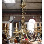 A GILT BRASS EIGHT BRANCH CHANDELIER with central vase-shaped column and eight scrolling branches,