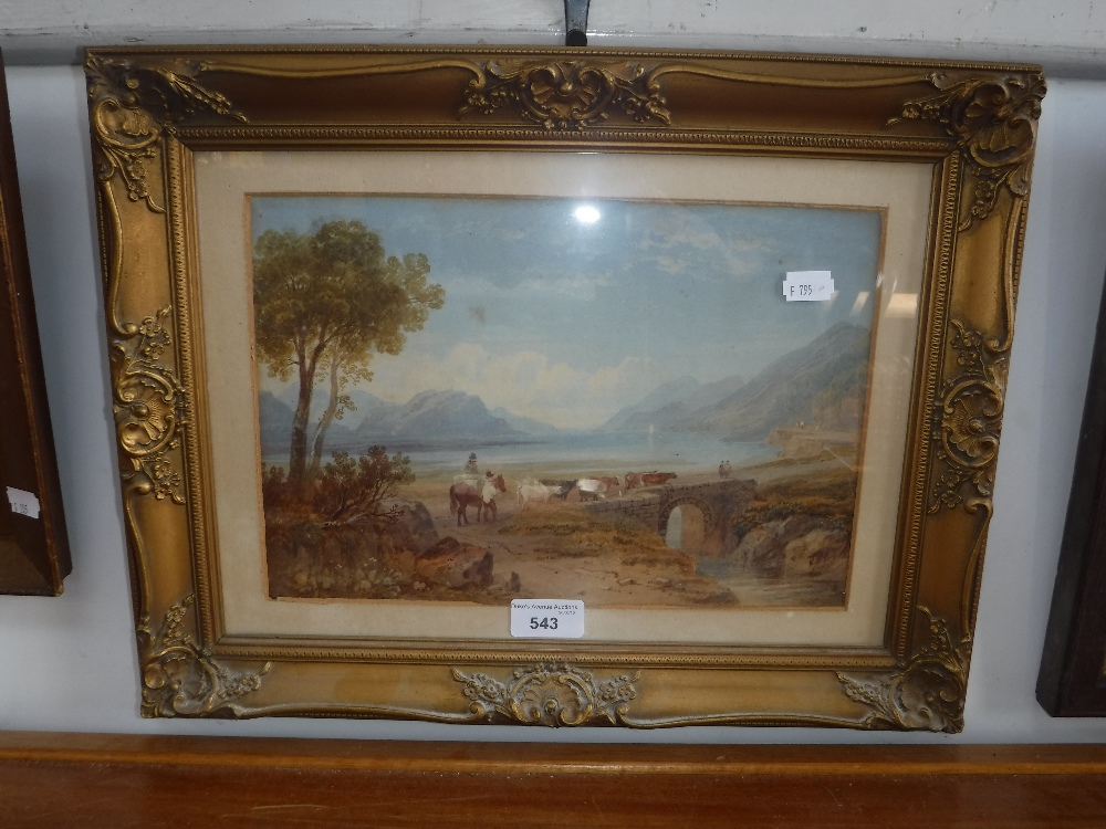 A 19TH CENTURY WATERCOLOUR of a lake scene with cattle in a gilt frame