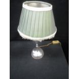 A SILVER TABLE LAMP on baluster stem with spreading base