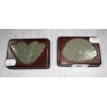 A PAIR OF ORIENTAL JADE PAPERWEIGHTS, the carved jade inset into hardwood bases