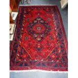 A RED GROUND PERSIAN DESIGN RUG 53" X 80" (plus fringes)