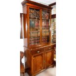 A GEORGE III MAHOGANY BOOKCASE, the upper section with twin glazed doors, above a base with two