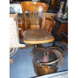 AN EDWARDIAN WALNUT REVOLVING OFFICE CHAIR, a copper coal scuttle and a pair of bellows