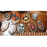 A COLLECTION OF HAND PAINTED SHIELDS mounted on oak, to include 'University of Birmingham', 'Floreat