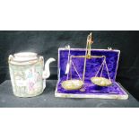 A CHINESE FAMILLE ROSE WINE POT and a set of cased scales