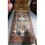 A BLUE GROUND PERSIAN RUG with geometric decoration, 39" x 73" and another orange ground rug 40" x