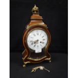 A FRENCH WALNUT-CASED BRACKET CLOCK, striking on a bell, with enamelled dial and shaped glass door