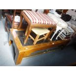 A MAHOGANY FRAME GLASS TOP COFFEE TABLE, 59" long and three stools