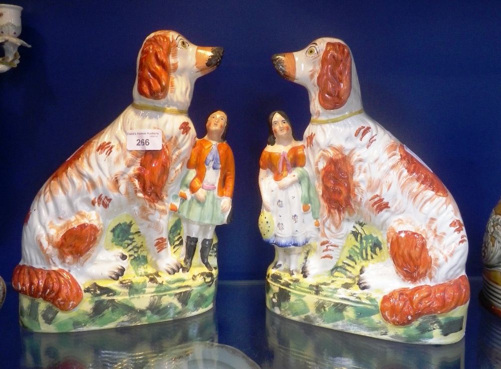 A PAIR OF LARGE 19th CENTURY STAFFORDSHIRE DOGS moulded with accompanying children, and brightly