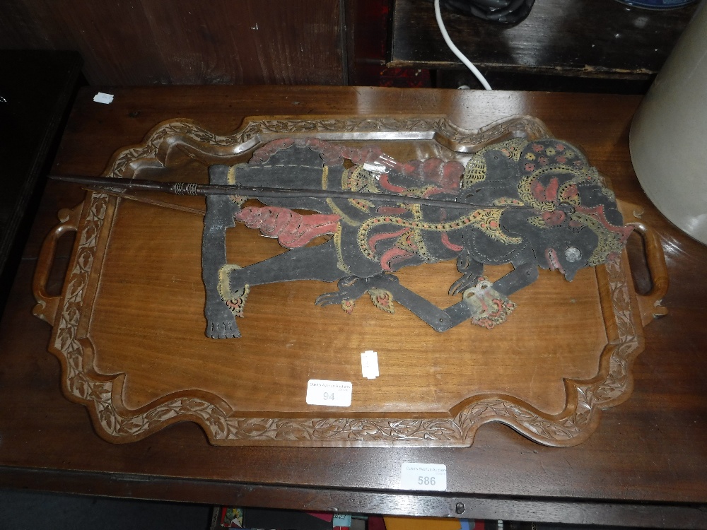 A CARVED HARDWOOD TRAY and a Thai shadow puppet