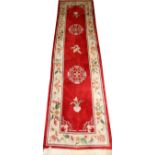 CHINESE RED RUNNER WITH BEIGE BORDER W 27", L 97"Having a red ground with two round floral