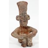 PRE-COLUMBIAN, TERRACOTTA SEATED FIGURE, H 8", W 5"Seated position with hands on knees, pierced