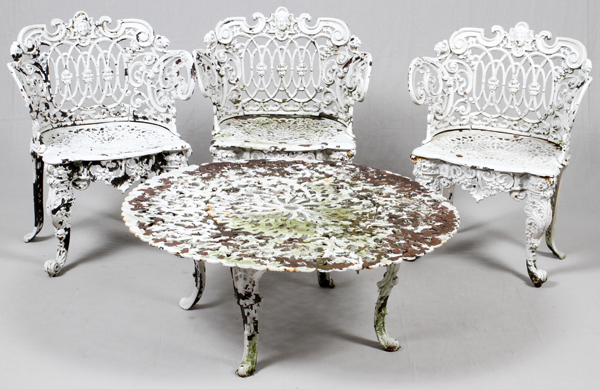 CAST IRON PATIO SET, 3 PCS,The set has a round coffee table, painted white, with pierced design