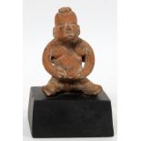 PRE-COLUMBIAN, TERRACOTTA SEATED FIGURE, H 4 1/2"seated figure with outstretched legs. Black painted