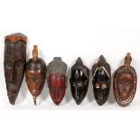 AFRICAN CARVED WOOD MASKS, SIX, H 14"-21", W 6"-7"A variety of masks with remnants of polychrome