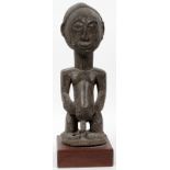 AFRICAN WOOD SEATED FIGURE, H 16"African male fertility figure on a mahogany base.- For High