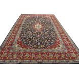 SIGNED PERSIAN TABRIZ, HAND WOVEN WOOL CARPET, W 8' 9", L 12' 4"Having five borders, navy ground