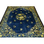 CHINESE HAND WOVEN WOOL RUG, C1900 W 8' 11", L 11' 5"Having a dark blue ground, 2 borders, yellow