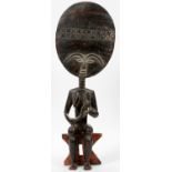 AFRICAN WOOD SEATED FIGURE, H 24", W 9"seated on an integral bench.- For High Resolution Photos