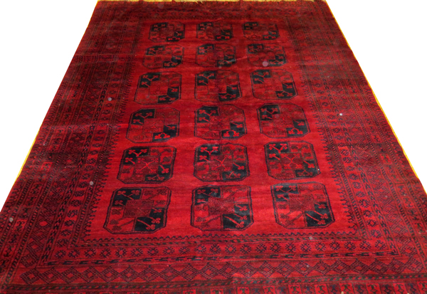 AFGHAN, HAND WOVEN WOOL RUG, W 8' 6", L 11' 6"Having a dark red ground, 5 borders with 18 spaced