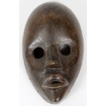 AFRICAN, CARVED WOOD MASK, H 7", W 4"Large eye holes and closed mouth with slit opening.- For High