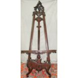 MAHOGANY HAND CARVED ARTIST EASEL, H 93", L 38", D 31"Having floral, acanthus, and scroll design.-