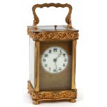 FRENCH BRONZE CARRIAGE CLOCK, EARLY 20TH C., H 6", L 3 1/4"Having beveled glass panels, a