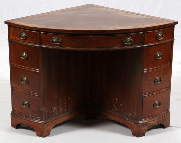 MAHOGANY CORNER DESK, H 30", W 46", D 33"Having inset leather top and a total of 8 drawers, one
