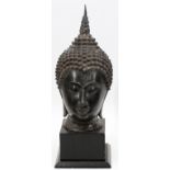 BRONZE BUDDHA HEAD, H 16 1/2", L 7 1/2"On a black wooden base with an overall height of 21 1/2".