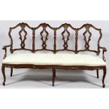 CARVED WALNUT CHAIRBACK SOFA, H 43", L 72", D 24"Having four chair-backs each with a carved shell