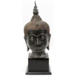 THAI BRONZE BUDDHA HEAD, H 16 1/2", L 7 1/2"On a black wooden base with an overall height of 21 1/
