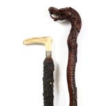 WALKING STICKS, 2 PCS.One having a carved dragon head, and one having a horn formed handle. From the