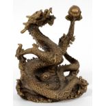 CHINESE BRASS DRAGON, H 7 1/2", L 6"Chinese brass dragon with a coiled tail, holding a metal