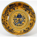 CHINESE PORCELAIN BOWL H 5", DIA 13.25"Having a mustard ground with blue dragon accents in the